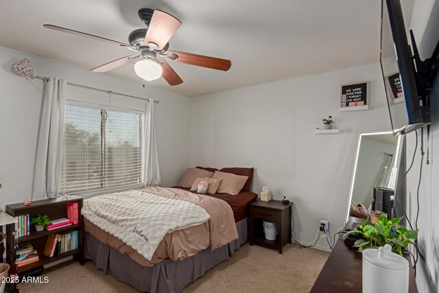 bedroom with light carpet and ceiling fan