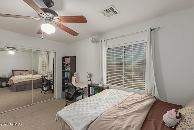 bedroom with carpet flooring, visible vents, a closet, and ceiling fan