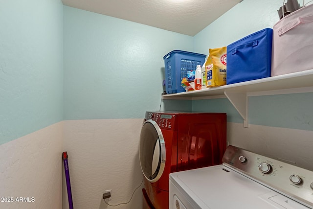 washroom featuring washer and clothes dryer and laundry area