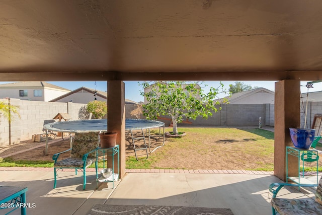 view of patio / terrace with a trampoline and a fenced backyard