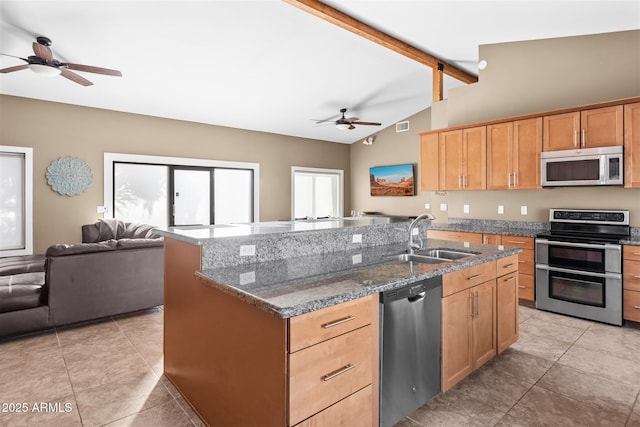kitchen featuring stainless steel appliances, a sink, a ceiling fan, open floor plan, and light tile patterned floors