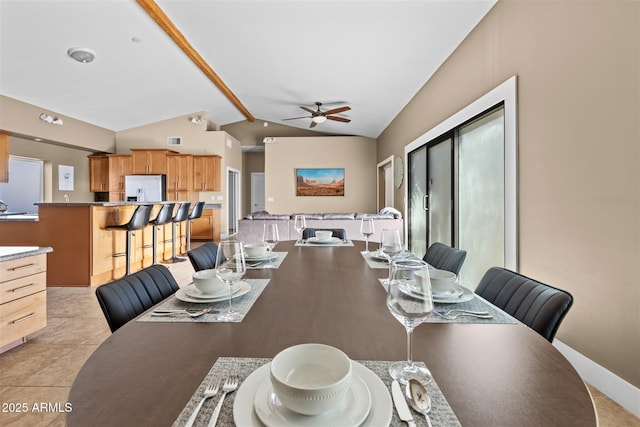 dining area featuring vaulted ceiling and a ceiling fan