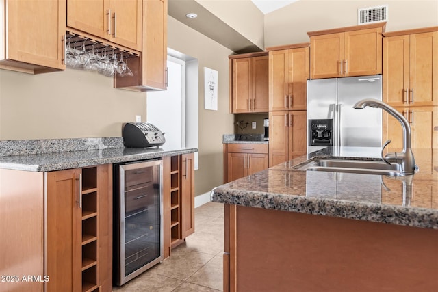 kitchen featuring wine cooler, a sink, light tile patterned flooring, stainless steel fridge, and open shelves