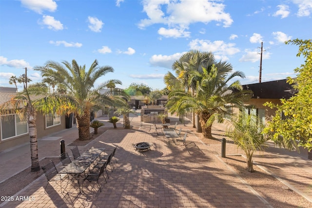view of home's community with a fire pit and a patio
