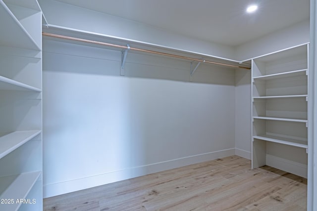 spacious closet with light hardwood / wood-style floors