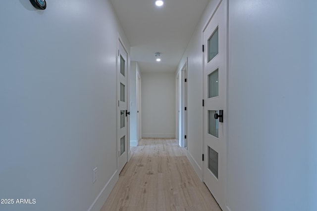 hallway with light hardwood / wood-style flooring