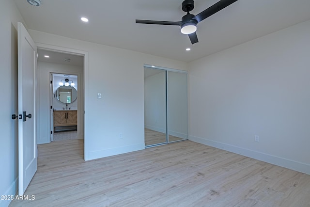 unfurnished bedroom featuring ceiling fan, a closet, and light hardwood / wood-style flooring