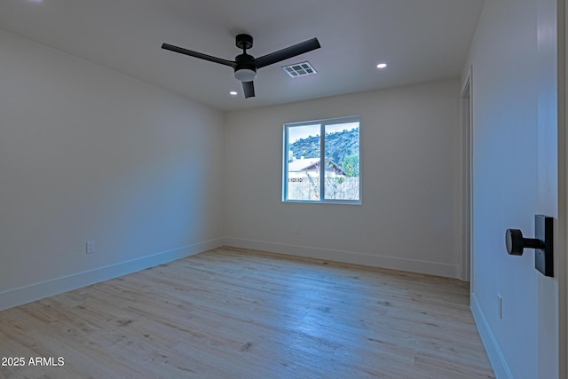 empty room featuring ceiling fan and light hardwood / wood-style flooring