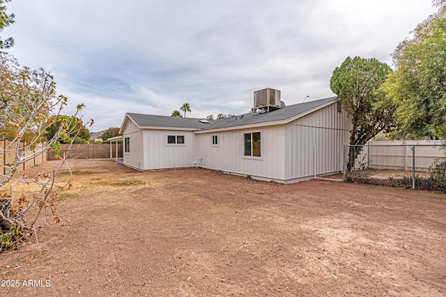 rear view of house featuring central AC unit