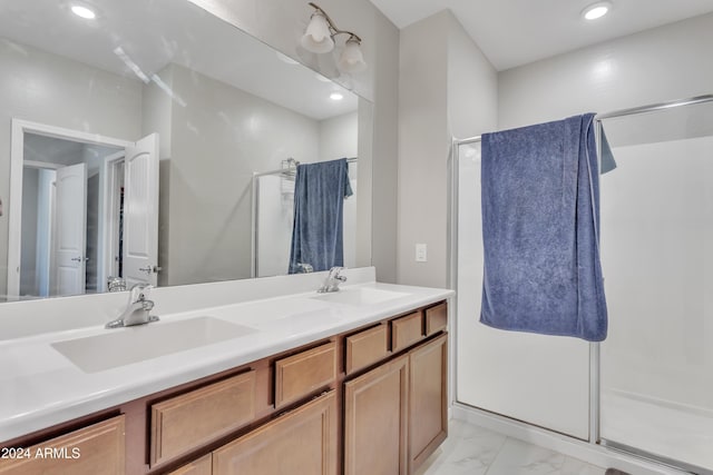 bathroom with a shower with door and vanity