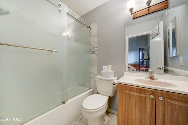 full bathroom featuring tile patterned floors, vanity, bath / shower combo with glass door, and toilet