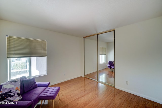 living area featuring light hardwood / wood-style flooring and a healthy amount of sunlight