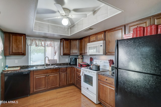 kitchen with black appliances, sink, ceiling fan, and light hardwood / wood-style flooring