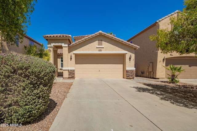 17493 N Costa Brava Ave, Maricopa, AZ 85139 - view of front of property featuring stucco siding, concrete driveway, a garage, stone siding, and a tiled roof