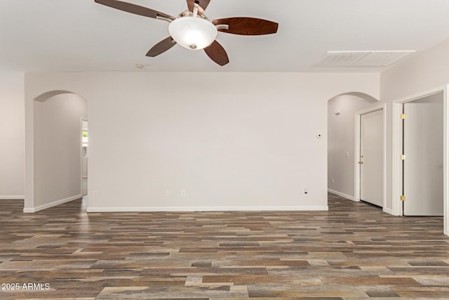 17493 N Costa Brava Ave, Maricopa, AZ 85139 - spare room featuring arched walkways, wood finished floors, and ceiling fan