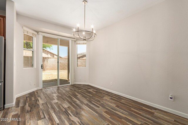 17493 N Costa Brava Ave, Maricopa, AZ 85139 - unfurnished dining area with a chandelier and dark wood-type flooring