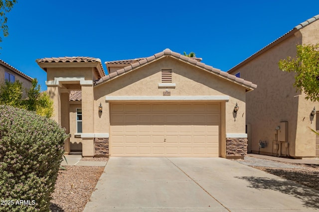 17493 N Costa Brava Ave, Maricopa, AZ 85139 - view of front facade with an attached garage, driveway, stucco siding, a tiled roof, and stone siding