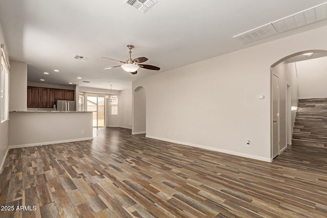 17493 N Costa Brava Ave, Maricopa, AZ 85139 - unfurnished living room with ceiling fan, dark wood finished floors, recessed lighting, and arched walkways