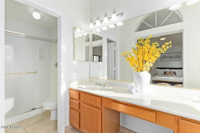 bathroom featuring vanity, a shower with shower door, toilet, and tile patterned flooring