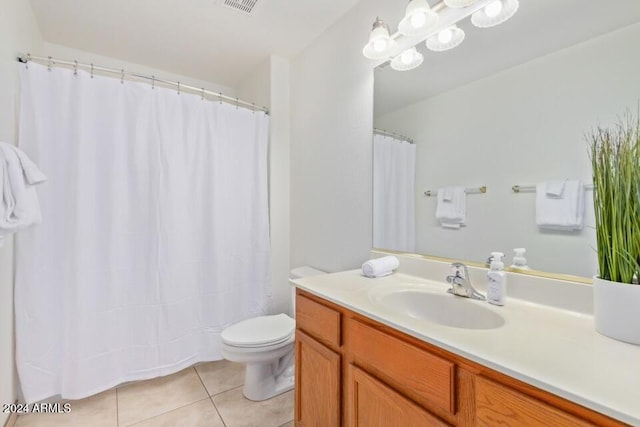 bathroom featuring vanity, toilet, and tile patterned flooring