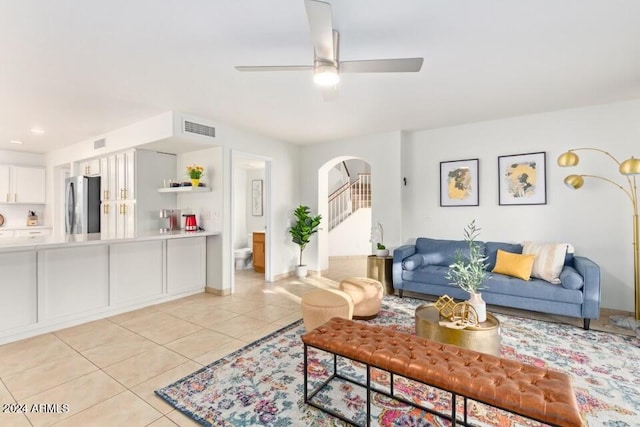 tiled living room with ceiling fan