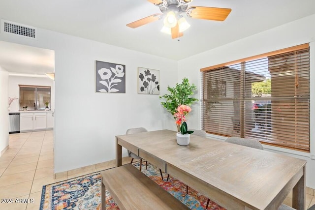 tiled dining space with ceiling fan