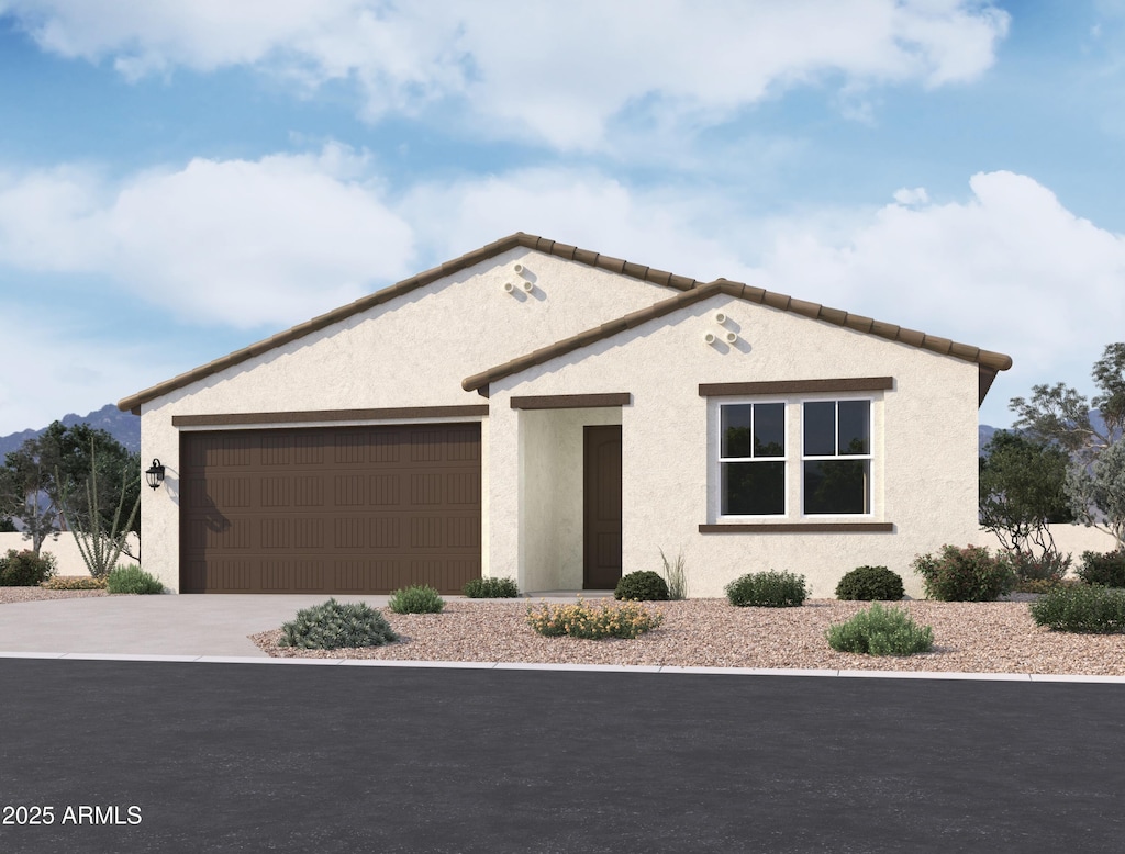 view of front facade featuring a garage, concrete driveway, and stucco siding