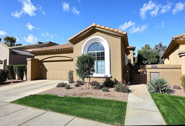 mediterranean / spanish-style house featuring an attached garage, a tile roof, driveway, a gate, and stucco siding