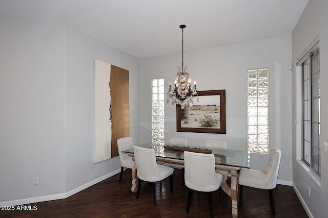 dining area with a notable chandelier, baseboards, and wood finished floors