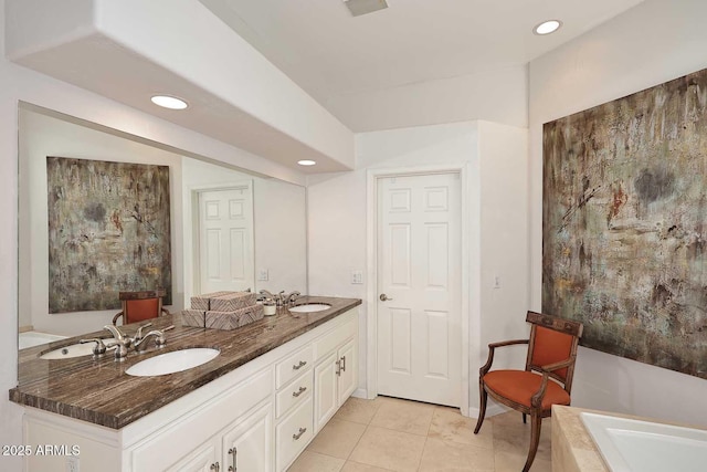 bathroom featuring double vanity, a bathing tub, a sink, and recessed lighting