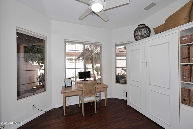 office featuring dark wood-style floors, a ceiling fan, and baseboards