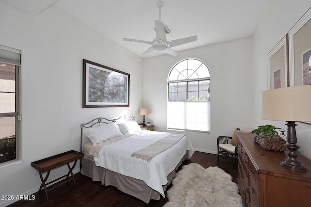 bedroom featuring a ceiling fan, baseboards, and wood finished floors