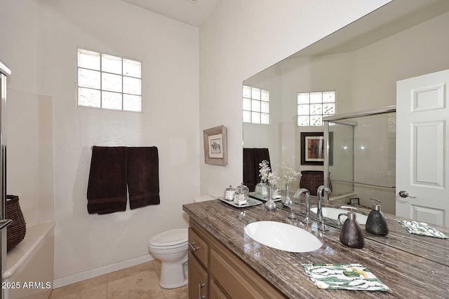 bathroom with tile patterned flooring, a healthy amount of sunlight, a shower with door, and vanity