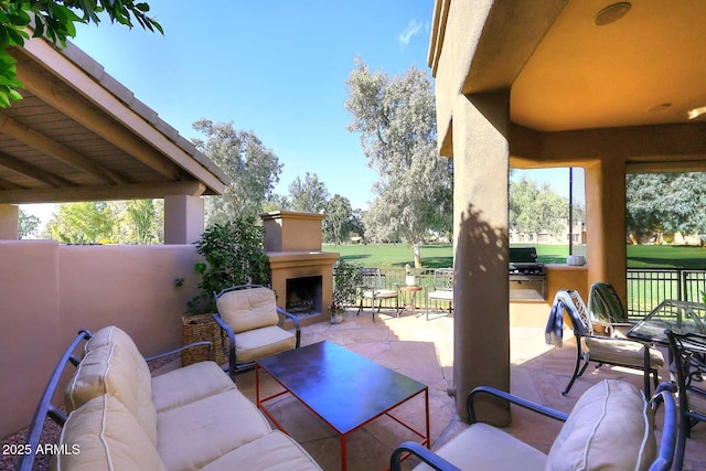 view of patio featuring grilling area and an outdoor living space with a fireplace