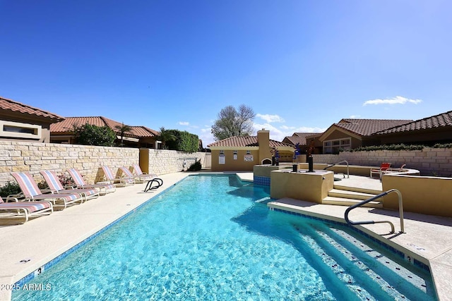 pool featuring a fenced backyard and a patio