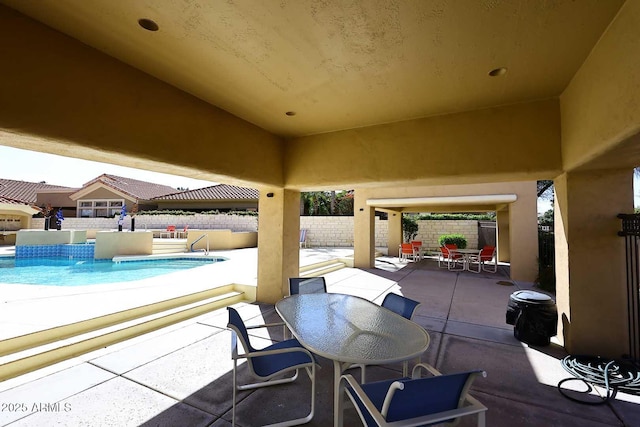 view of patio / terrace featuring a fenced in pool, outdoor dining space, and a fenced backyard