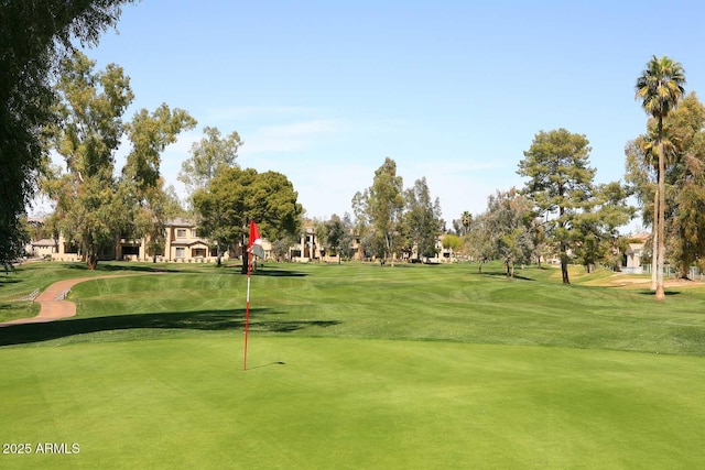 view of home's community featuring golf course view and a yard