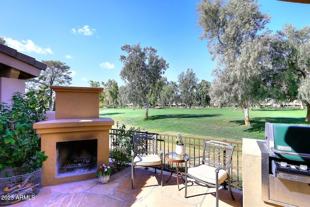 view of patio / terrace featuring an outdoor fireplace