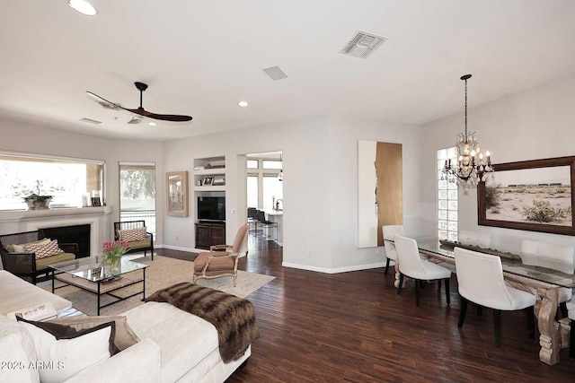 living area with a fireplace, visible vents, wood finished floors, and recessed lighting