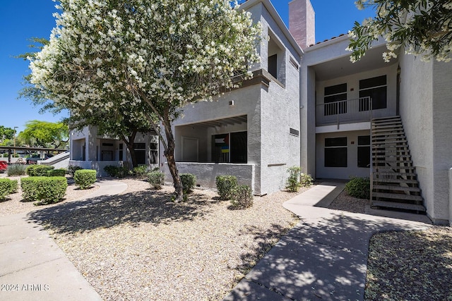 11375 E Sahuaro Dr Unit 1055, Scottsdale, AZ 85259 - view of front of property featuring stucco siding and a chimney
