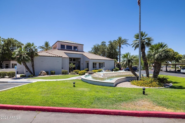 11375 E Sahuaro Dr Unit 1055, Scottsdale, AZ 85259 - mediterranean / spanish-style home with stucco siding, a front yard, and a tiled roof