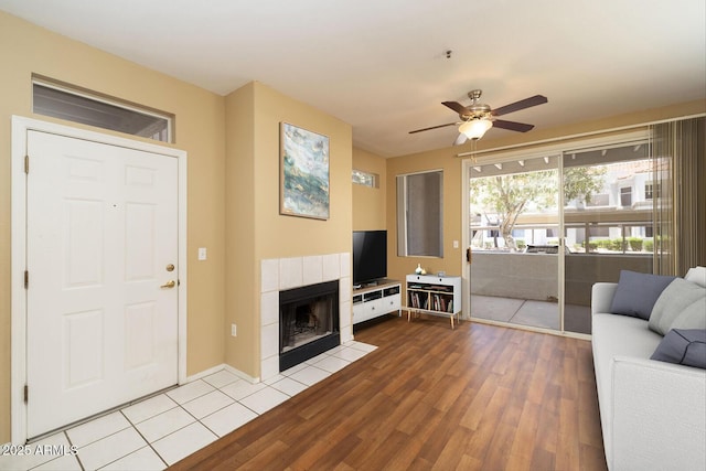 11375 E Sahuaro Dr Unit 1055, Scottsdale, AZ 85259 - living room with a ceiling fan, wood finished floors, and a fireplace