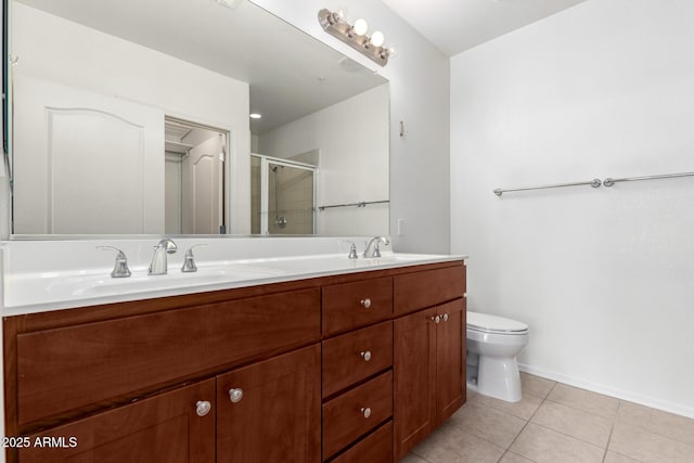 bathroom featuring tile patterned flooring, vanity, toilet, and an enclosed shower