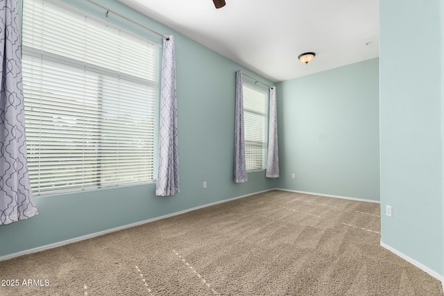 carpeted empty room with ceiling fan