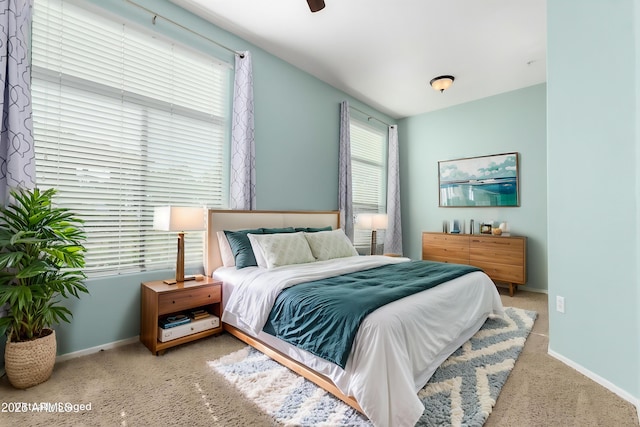 bedroom featuring ceiling fan and light colored carpet