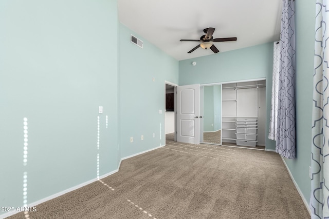 unfurnished bedroom featuring ceiling fan, carpet floors, and a closet