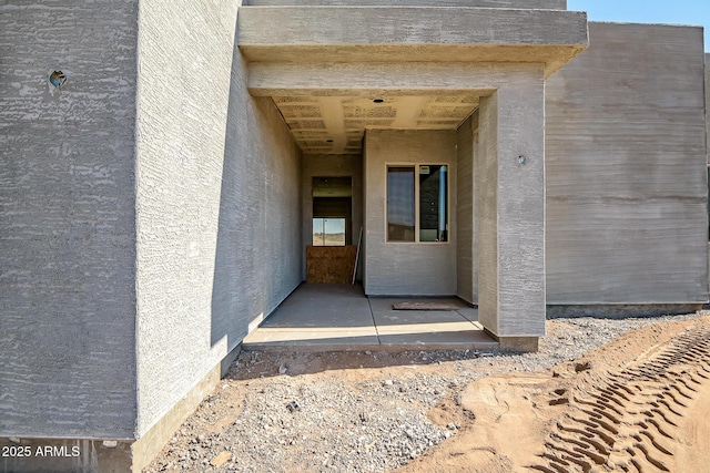 entrance to property with stucco siding