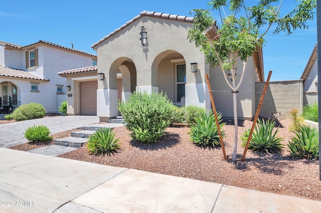 19908 W Montecito Ave, Litchfield Park, AZ 85340 - mediterranean / spanish-style house with stucco siding, a garage, a tiled roof, and driveway