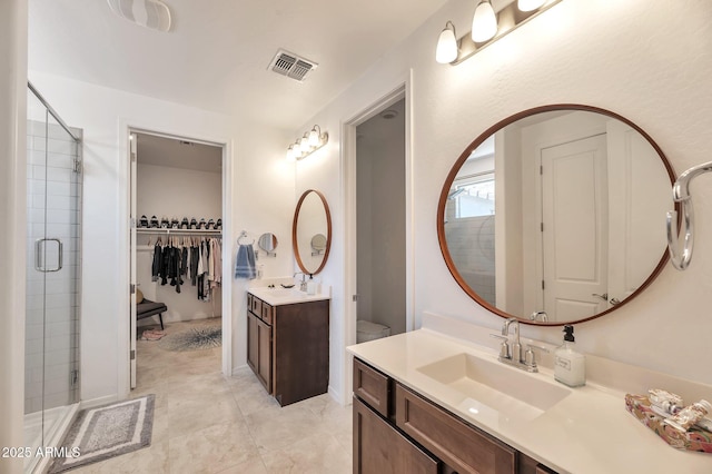 19908 W Montecito Ave, Litchfield Park, AZ 85340 - full bath with vanity, a shower stall, a walk in closet, and tile patterned floors