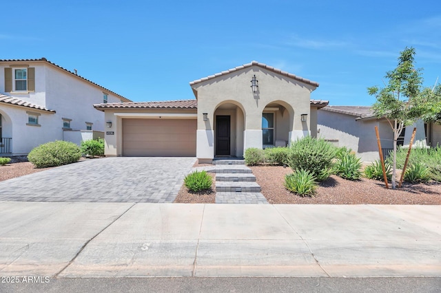 19908 W Montecito Ave, Litchfield Park, AZ 85340 - mediterranean / spanish-style home featuring stucco siding, a tiled roof, decorative driveway, and a garage
